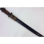 An Antique brass and mahogany-mounted bayonet. Est