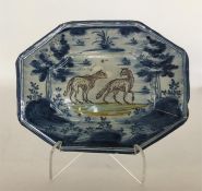 A Continental tin-glazed octagonal dish painted in