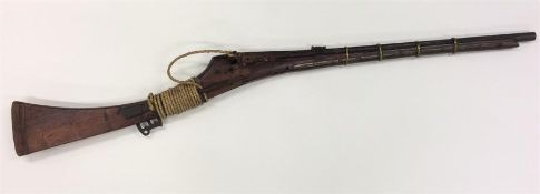 A South East Asian rifle with brass mounts. Est. £