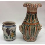 A Continental pottery green and ochre decorated va