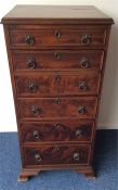 An antique mahogany narrow secretaire chest on bra