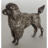 A cast silver figure of a Poodle in standing posit