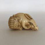 A signed carved ivory netsuke in the form of a rab
