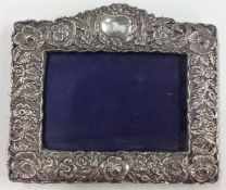 A good embossed silver picture frame decorated wit