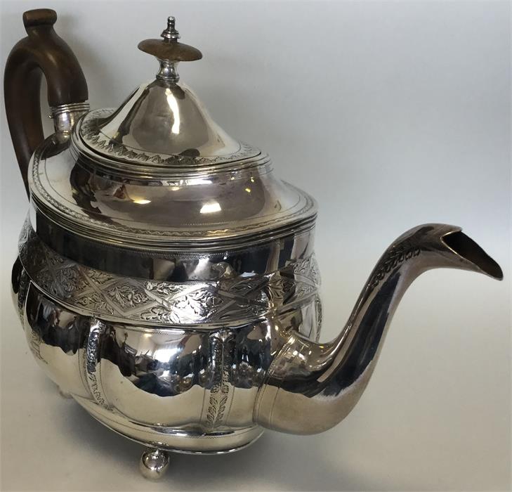 A Georgian silver bright cut teapot on ball feet. - Image 3 of 3