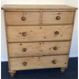 A pine chest of five drawers on bun feet. Est. £50