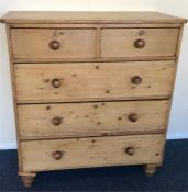 A pine chest of five drawers on bun feet. Est. £50