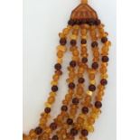 An amber-mounted five string necklace. Approx. 82