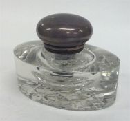 A small glass and silver hinged-top inkwell. London. Est. £50