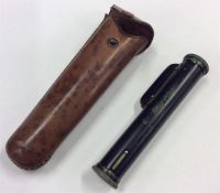 A leather-mounted gunsite. Est. £30 - £40.