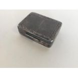 A small silver modern rectangular pill box with eng