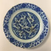 A Persian pottery blue and white saucer dish on ra