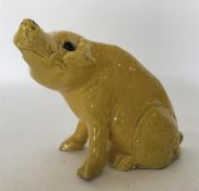 An Oriental yellow pottery glazed figure of a seat