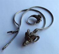 An unusual silver necklace mounted with a ram's he