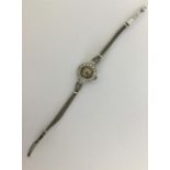 A heavy lady's diamond cocktail watch on gold mesh