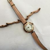 A 9 carat watch strap together with a 9 carat watc
