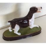BESWICK: A figure of a liver and white spaniel on