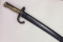 An Antique brass and steel bayonet. Est. £30 - £40