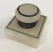 A silver mounted and onyx inkwell with hinged top.