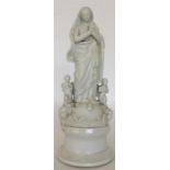 A Parian figure of the Virgin Mary standing with h