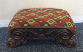 A Regency mahogany upholstered top stool with scro
