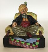 A Royal Doulton porcelain figure of Abdullah seate