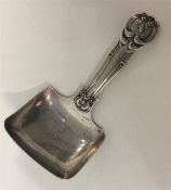 An unusual silver caddy spoon decorated with flowe