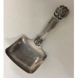 An unusual silver caddy spoon decorated with flowe