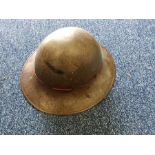 A Second World War old tin hat. Est. £20 - £30.