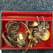 A tray containing a silver watch chain, brooches e