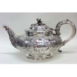 An embossed floral teapot decorated with flowers,