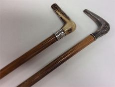 Two silver mounted walking sticks with engraved de