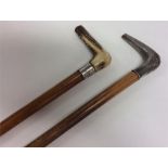 Two silver mounted walking sticks with engraved de