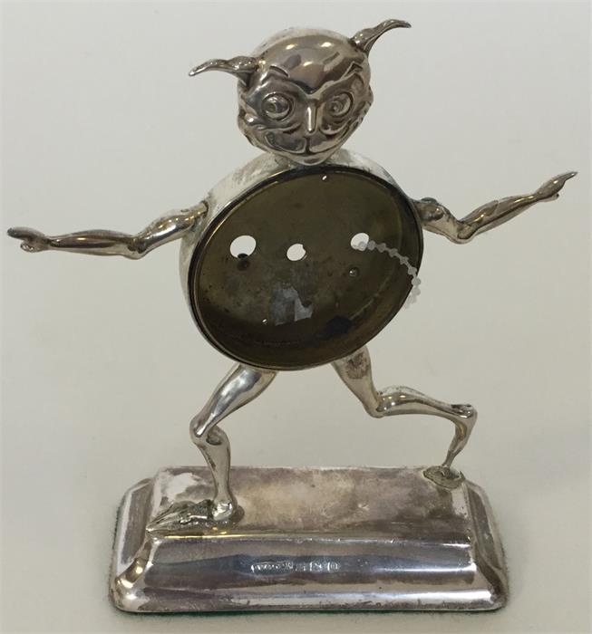 A novelty silver watch holder in the form of a jok