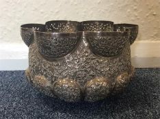 A large circular silver Indian bowl decorated with