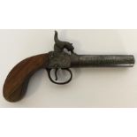 A pocket pistol with chased decoration and mahogan