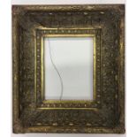 A gilt frame decorated with scrolls and reeding. A
