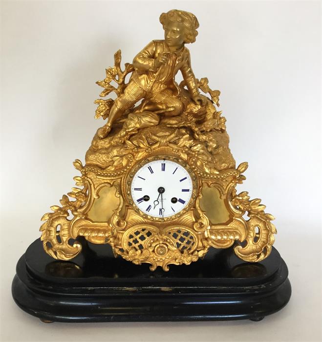 A good French gilt mantle clock with white enamell