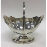 An Edwardian silver sugar basket with wavy edge an