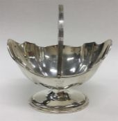 An Edwardian silver sugar basket with wavy edge an