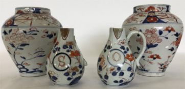 A pair of Imari oviform porcelain vases painted wi