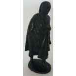 A small bronzed figure of a walking woman. Approx.