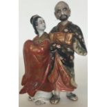 A Japanese porcelain group modelled as a courtesan