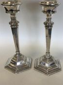 A pair of silver tapering bedroom candlesticks of