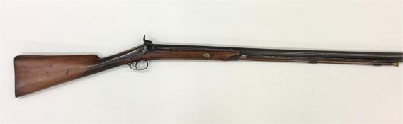 A long mahogany rifle, by Nock, with textured stoc