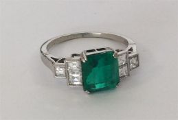 A good emerald and diamond single stone, the squar