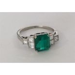 A good emerald and diamond single stone, the squar