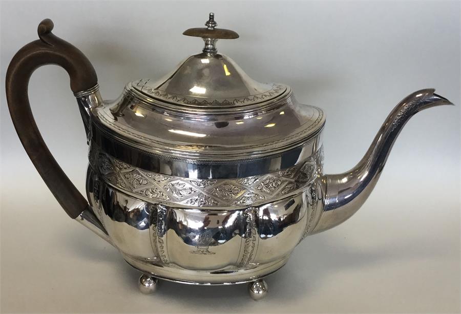 A Georgian silver bright cut teapot on ball feet. - Image 2 of 3