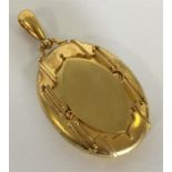 A good quality Victorian 15 carat oval locket with