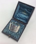 A boxed Edwardian silver napkin ring decorated with flowe